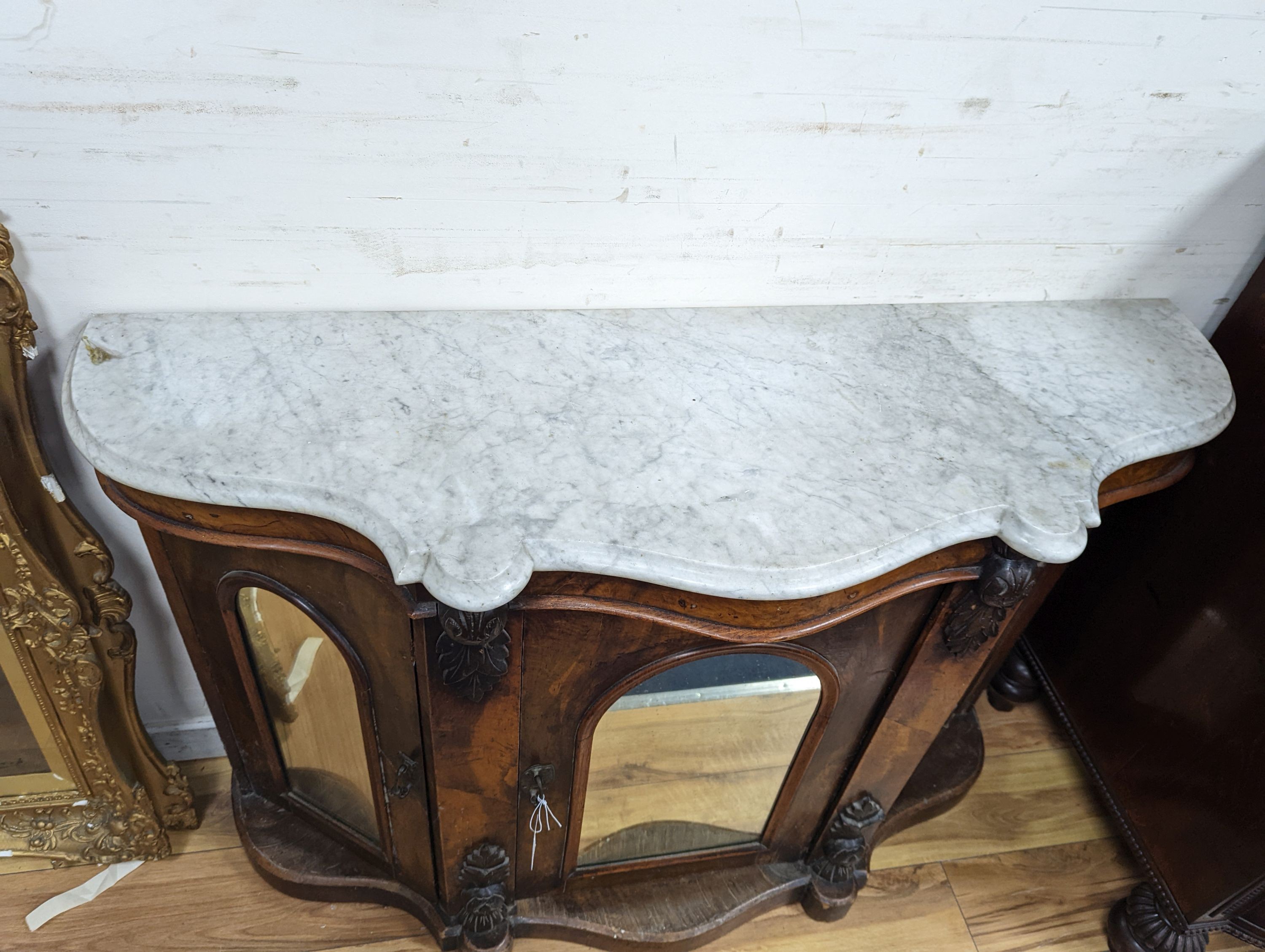 A late Victorian walnut and marble topped serpentine front side cabinet, width 120cm, depth 36cm, height 83cm